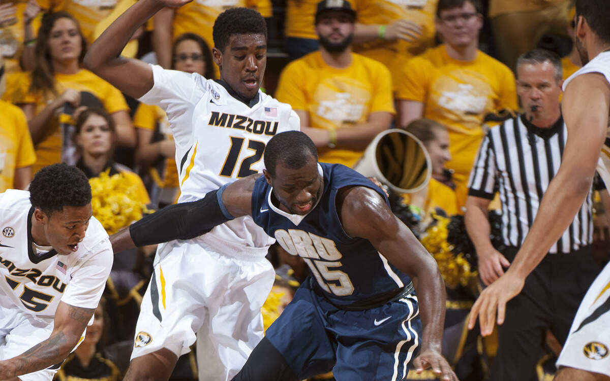 Oral Roberts' Obi Emegano, right, loses control of the ball as Missouri's Wes Clark, left, and Namon Wright defend during the first half of an NCAA college basketball game Wednesday, Nov. 19, 2014, in Columbia.