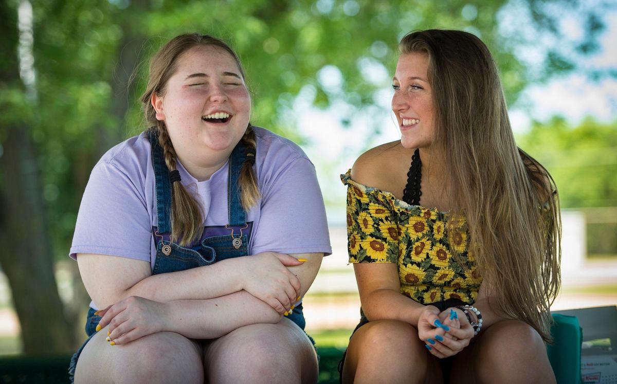 Jordyn Walker, 16, and her best friend, McKenna Hill, 18, share a laugh after a picnic earlier this month at Heritage Park in Smithville.