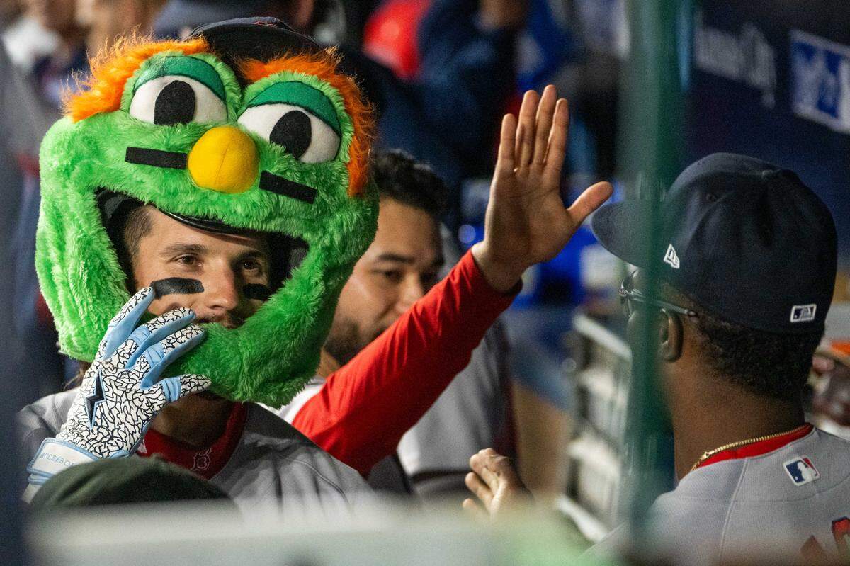Boston Red Sox left fielder Jarren Duran wears mascot headgear after hitting a home run against the Kansas City Royals during the ninth inning of a game at Kauffman Stadium on Tuesday, May 19, 2026.