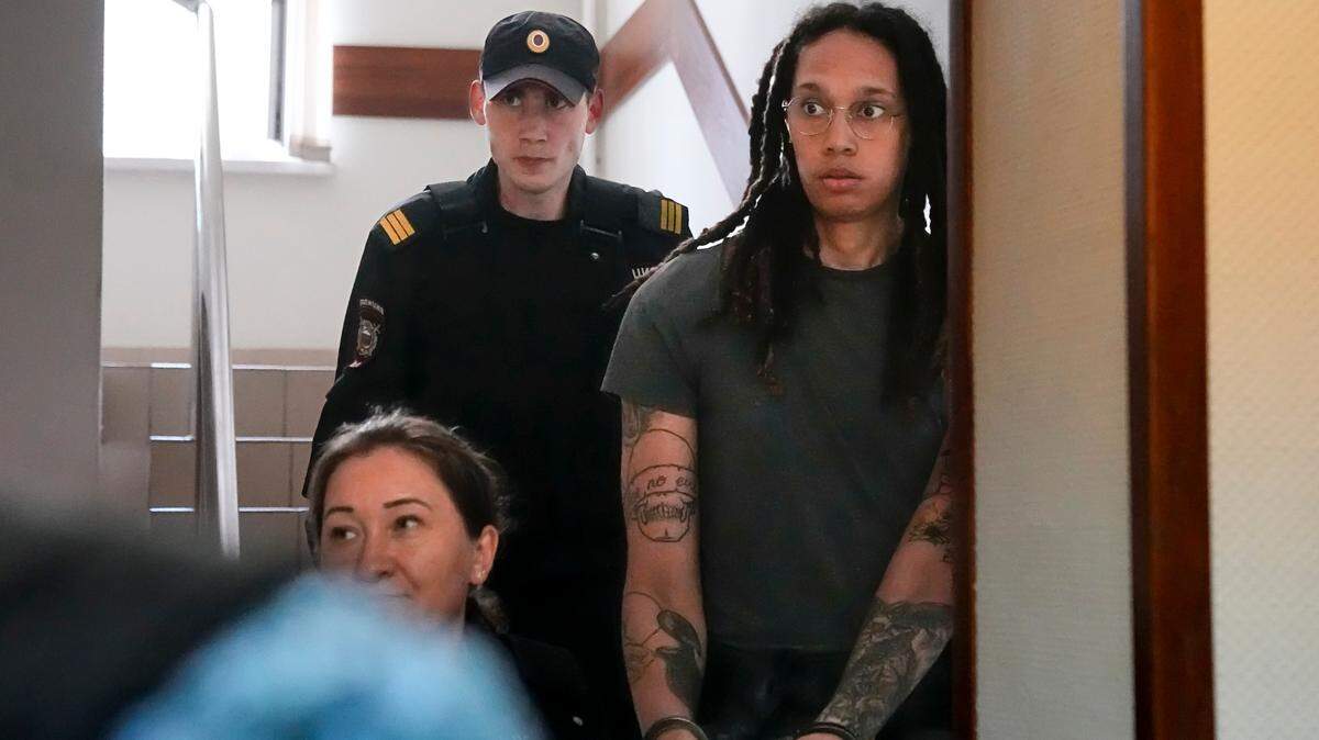 WNBA star and two-time Olympic gold medalist Brittney Griner is escorted to a courtroom for a hearing in Khimki just outside Moscow, Russia. More than four months after she was arrested at a Moscow airport for cannabis possession, American basketball star Brittney Griner had a preliminary hearing ahead of her trial. (AP Photo/Alexander Zemlianichenko)