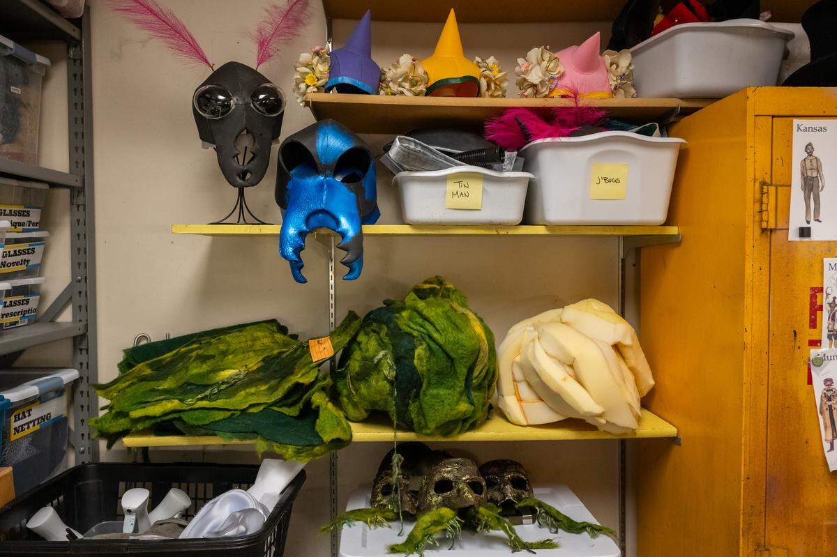 Assorted headgear line the shelves in Joey Gee’s craft room at the Spencer Theatre, in preparation for Kansas City Repertory  Theater’s rendition of ‘The Wizard of Oz,’ on Tuesday, April 28, 2026. The headgear was crafted by Joey Gee based on designs from Sully Ratke.