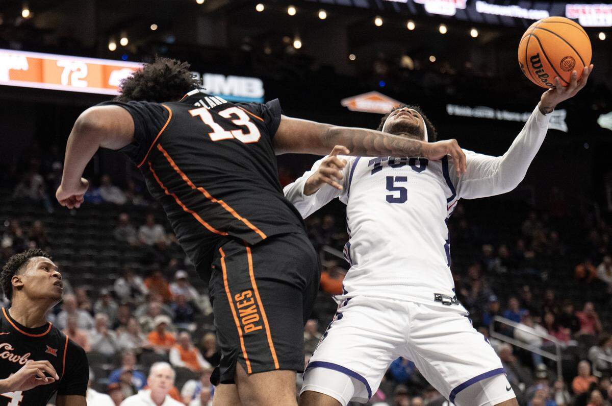 Texas Christian University Horned Frogs forward Micah Robinson (5) was fouled by Oklahoma State Cowboys center Mekhi Ragland (13) during the second half of the Big 12 Men's Basketball Tournament at T-Mobile Center on Wednesday, March 11, 2026, in Kansas City. TCU defeated OSU, 95-88.