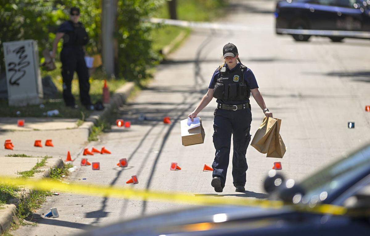 Police and crime scene investigators were on the scene collecting evidence where three people died and five were injured following a shooting early Sunday, June 25, 2023, near 57th Street and Prospect Avenue in Kansas City.