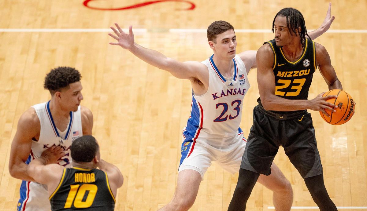 Kansas Jayhawks forward Parker Braun (23) guards Missouri Tigers forward Aidan Shaw (23) during an NCAA basketball game on Saturday, Dec. 9, 2023, in Lawrence, Kan.