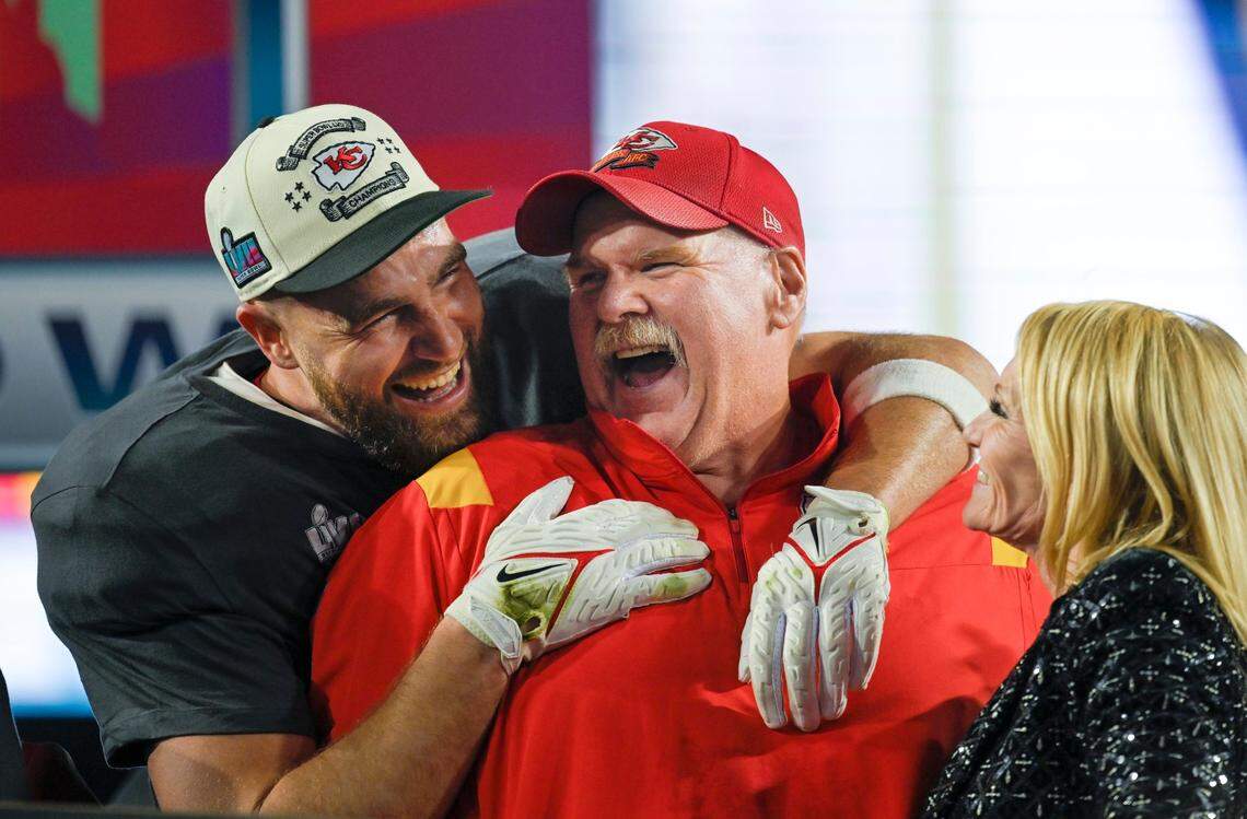 Travis Kelce hugs Chiefs head coach Andy Reid as Tammy Reid looks on after the Chiefs won Super Bowl LVII, defeating the the Philadelphia Eagles, 38-35, on Feb. 12, 2023, at State Farm Stadium in Glendale, Arizona. 