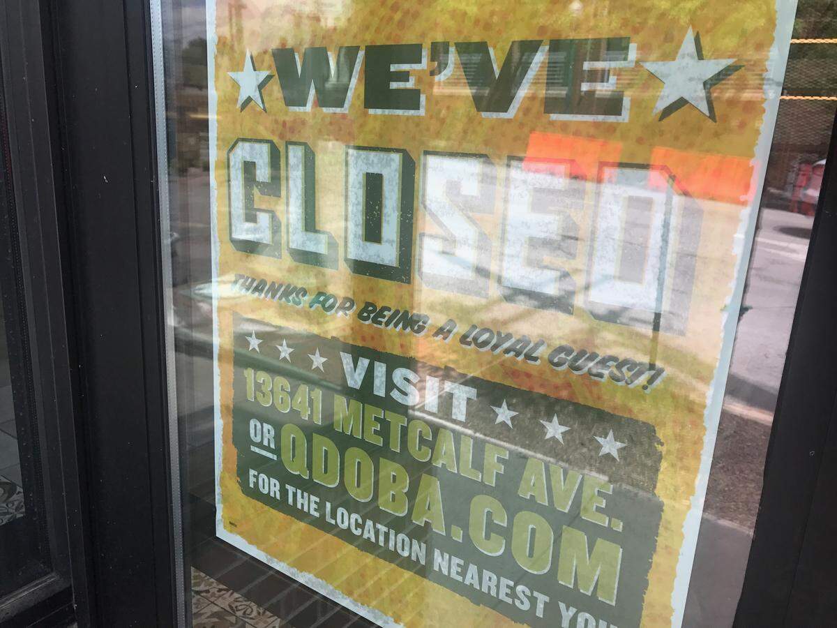 At the Westport Qdoba, a sign on the door says “We’ve closed” and “visit 13641 Metcalf Ave.”