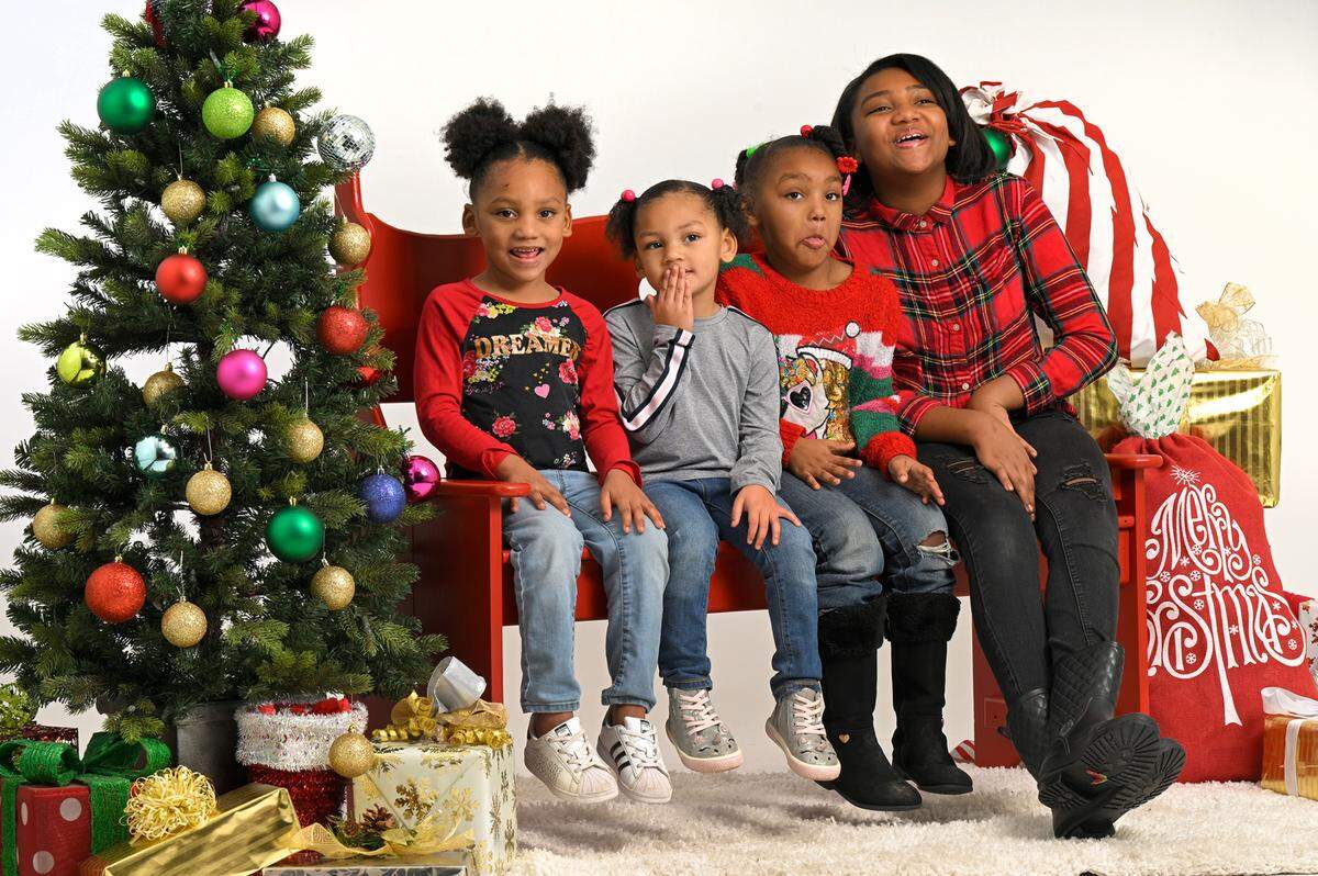 The daughters of Ashley Ramsey of Kansas City enjoyed a visit to the Soul of Santa breakfast on Saturday, where Star reporters, editors and photographers volunteered to create holiday family portraits for some 22 families. The girls, Zera Williams, 4, from left, Marliyah Williams, 3, AmiYah, 5, and Eva Williams, 10, had fun posing with one another.