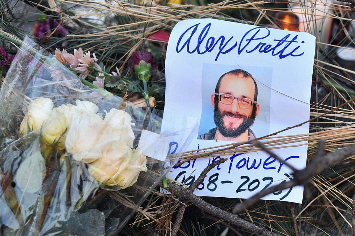 Flowers are left at a makeshift memorial in the area where Alex Pretti was shot dead a day earlier by federal immigration agents in Minneapolis, Minnesota, on January 25, 2026. On January 24, federal agents shot dead US citizen Alex Pretti, a 37-year-old ICU nurse, while scuffling with him on an icy roadway, less than three weeks after an immigration officer shot and killed Renee Good, also 37, in her car. His killing sparked new protests and impassioned demands by local leaders for the Trump administration to end its operation in the city. (Photo by Octavio JONES / AFP via Getty Images)