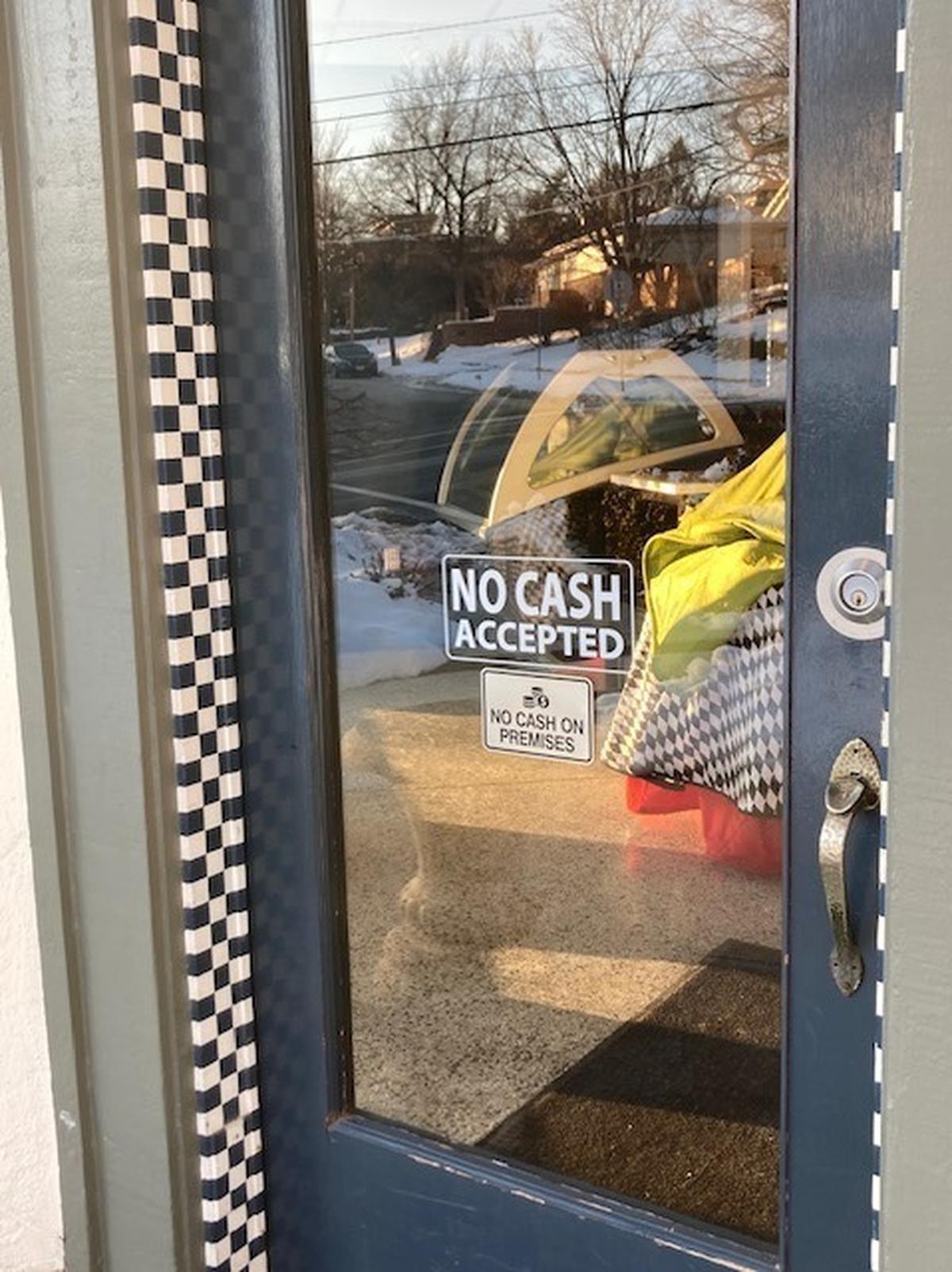 At Annedore’s Fine Chocolates in Westwood Hills signs declare “No cash accepted” and “No cash on premises.”