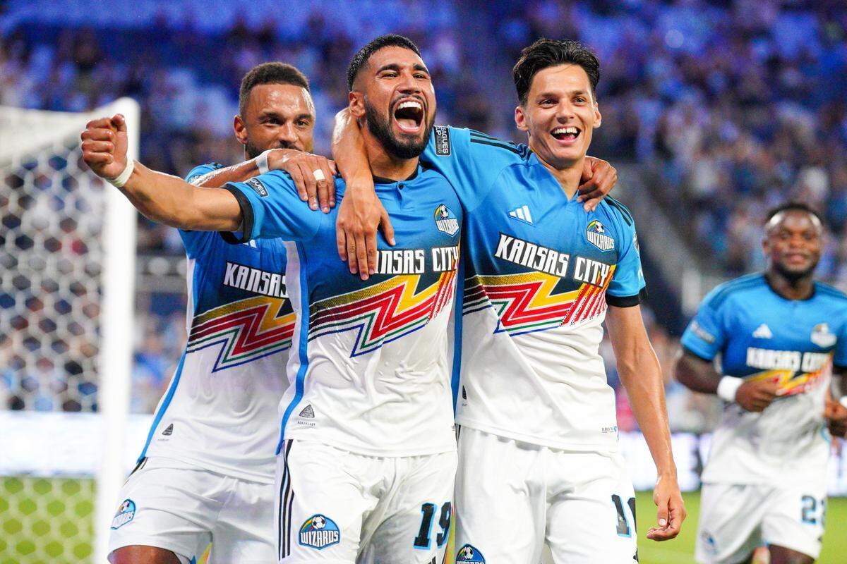 Sporting Kansas City defender Robert Castellanos is flanked by forwards Khiry Shelton, left, and Daniel Salloi after scoring on a header against the Chicago Fire during Sunday night’s Leagues Cup match at Children’s Mercy Park in Kansas City, Kan.