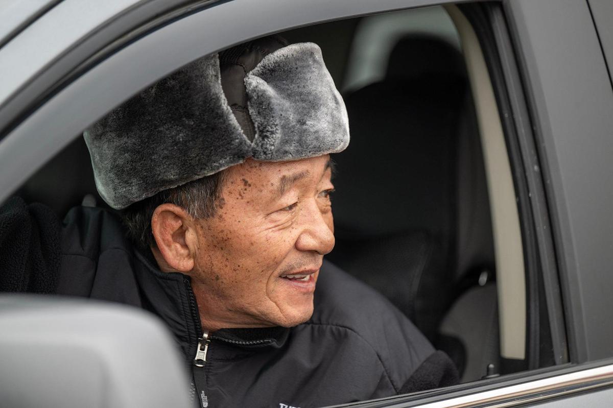 John Oh of Leavenworth, Kansas, looked on from the warm of his car as a large crowd of customers waited to enter the Costco upon opening on Saturday, Jan. 4, 2025, in midtown Kansas City. The winter storm forecast is driving people to stock up on supplies. The storm is expected to bring heavy snow, rain, ice and wind to the to the area.