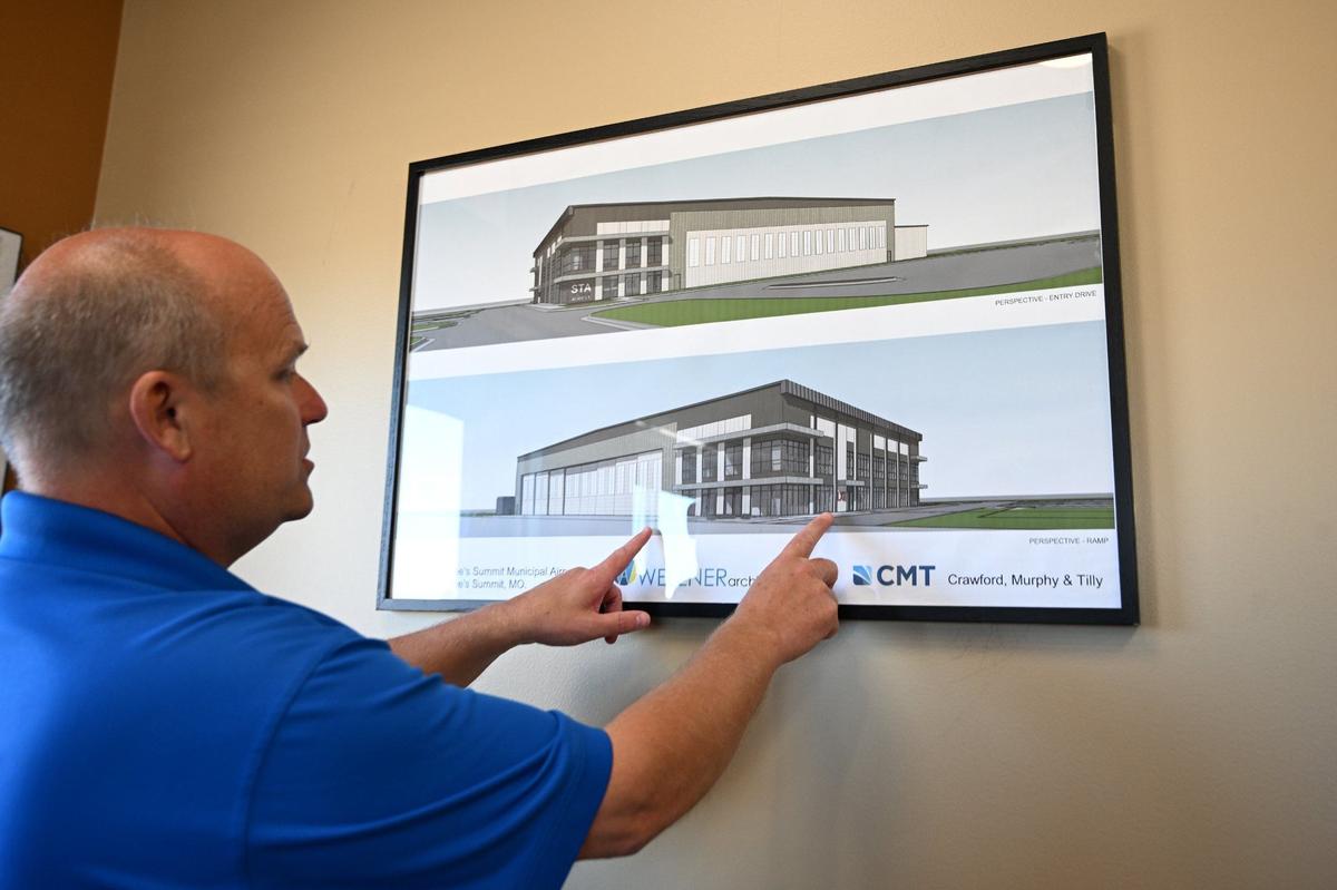 Joel Arrington, airport manager at Lee’s Summit Municipal Airport, explains a rendering of Hangar Two while giving a tour of the airport on Tuesday, Oct. 1, in Lee’s Summit.