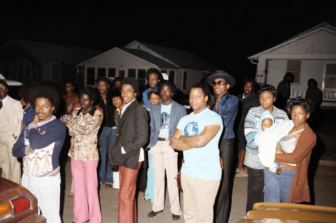 Dozens of concerned neighbors gathered outside 6934 S. Benton Ave. as detectives searched the home’s stoop for evidence.