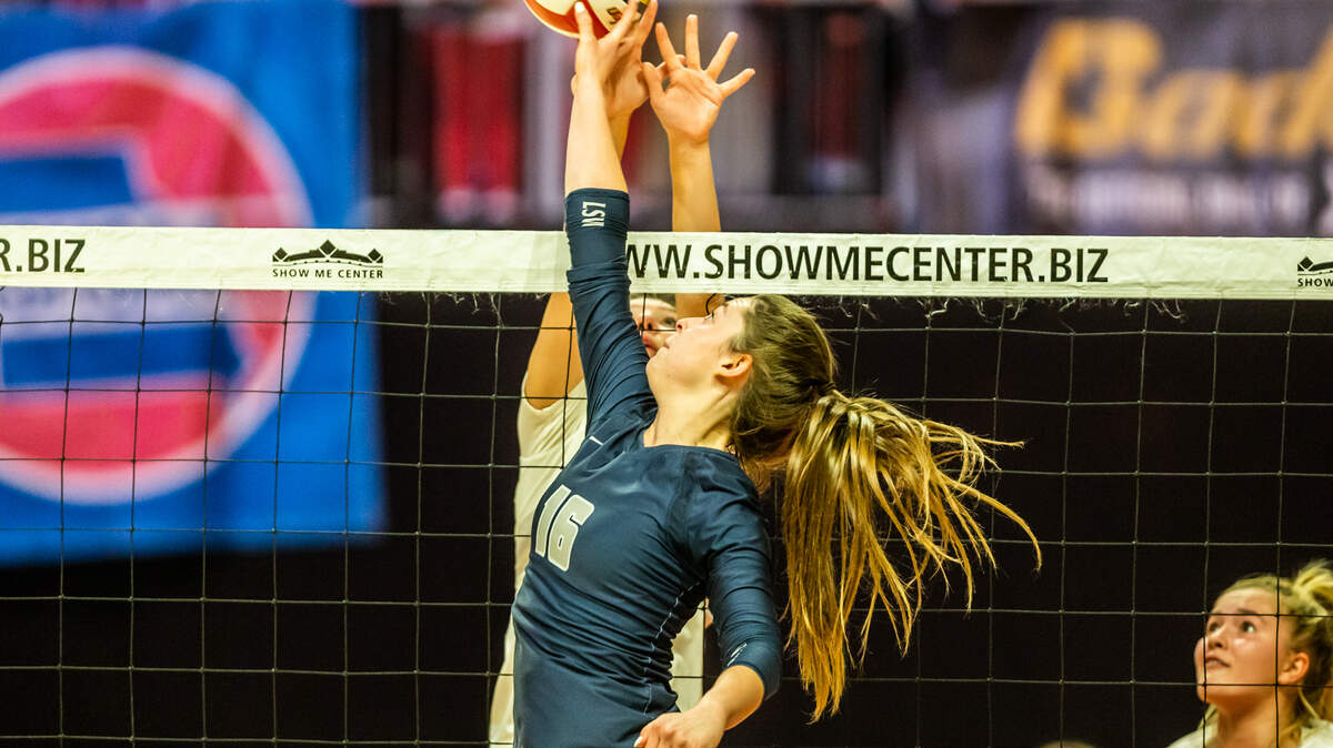 Lee’s Summit West’s Lacey Higgins tips the ball during the Class 5 championship volleyball match on Friday at the Show Me Center in Cape Girardeau. Cor Jesu defeated Lee’s Summit West 3-1. Gordon Radford | Special to the KC Star.