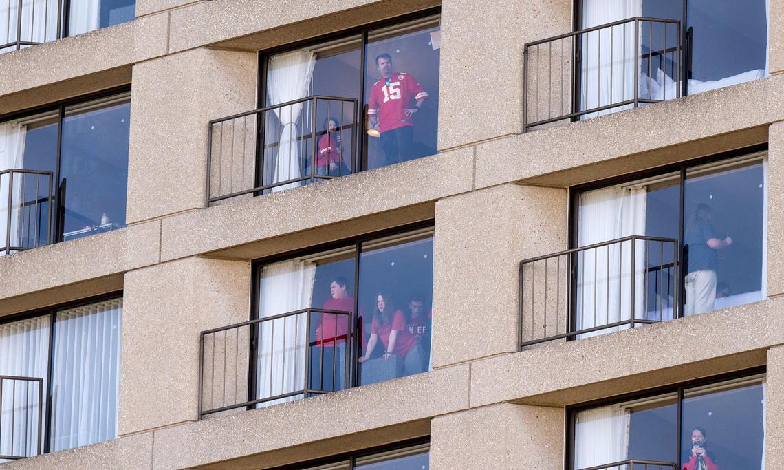 People look out of their windows from The Westin Hotel after a shooting broke out following the Kansas City Chiefs Super Bowl LVIII victory parade on Wednesday, Feb. 14, 2024, in Kansas City.