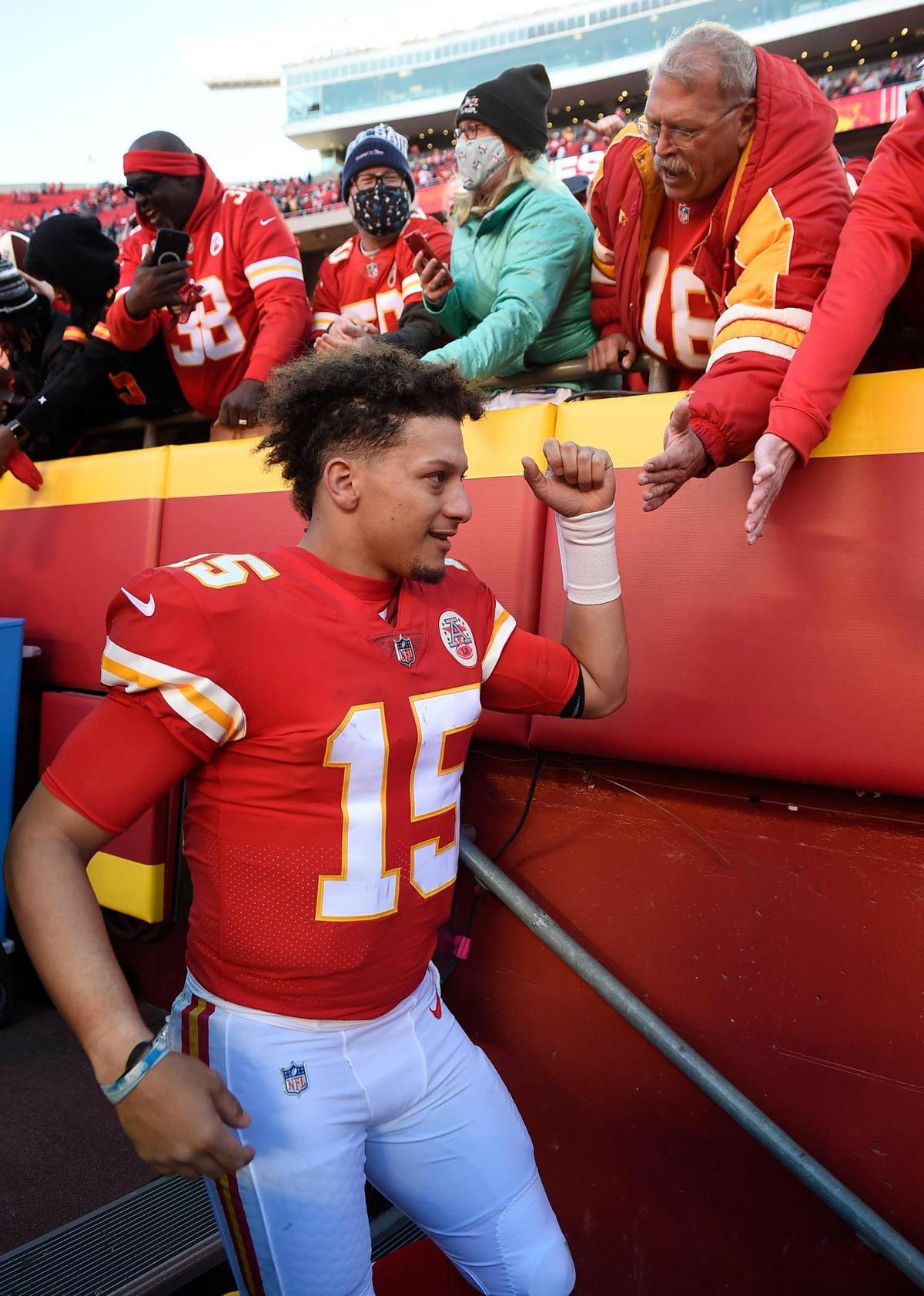 Chiefs quarterback Patrick Mahomes high fives with fans after the Kansas City’s 48-9 win over the Las Vegas Raiders Sunday at Arrowhead Stadium