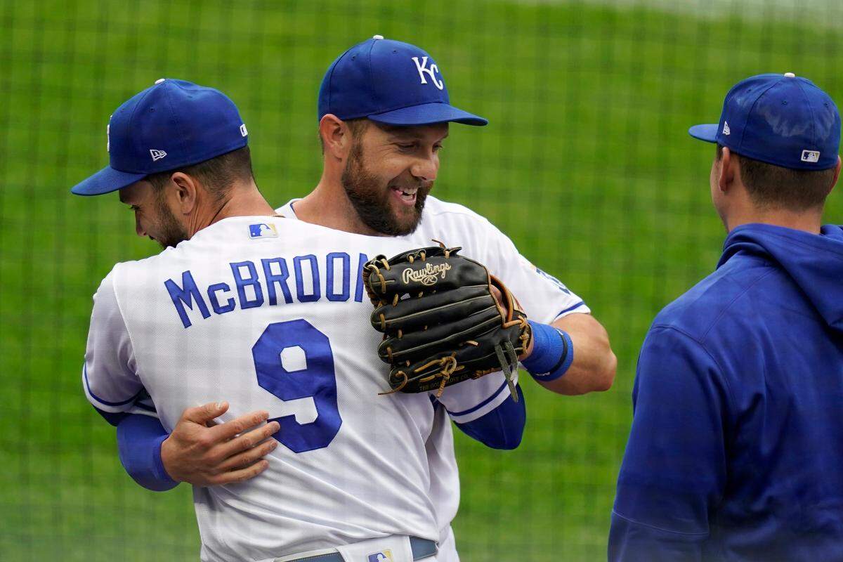 Kansas City Royals left fielder Alex Gordon, middle, is hugged by teammate Ryan McBroom (9) after being taken out of a baseball game against the Detroit Tigers during the second inning at Kauffman Stadium in Kansas City, Mo., Sunday, Sept. 27, 2020. It was Gordon’s last game as a Royal. (AP Photo/Orlin Wagner)