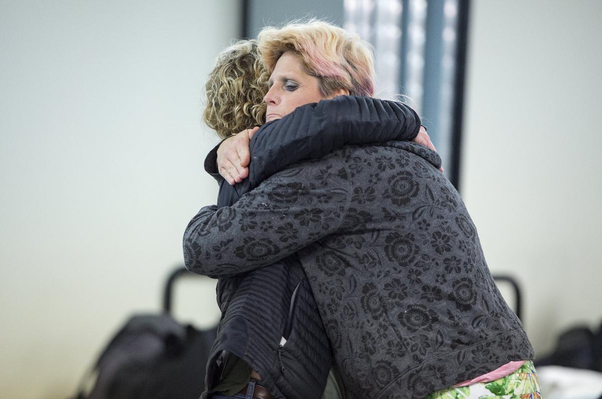 Barb McEver (left), co-founder of Project 1020, gets a heartfelt hug from Susan Goodsell-Williams, a homeless woman staying recently at the shelter. Goodsell-Williams said she might have frozen to death if not for the shelter.