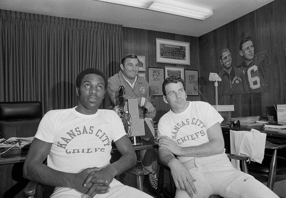 Chosen offensive players of the week, Otis Taylor, left, and quarterback Len Dawson, right, of the Kansan City Chiefs, watch game films shown by head coach Hank Stram. Taylor and Dawson were cited for their play in a 1971game with the Washington Redskins. Taylor made a one handed catch of Dawson’s pass in the closing minutes of the game to break a 20-20 tie. The Chiefs won the game, 27-20.