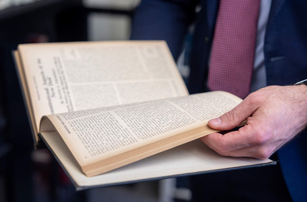 Shawn Lee, a Kansas City-based attorney, pages through a book in the Jackson County Law Library’s downtown Kansas City location. The location will close down as its lease expires at the end of May.