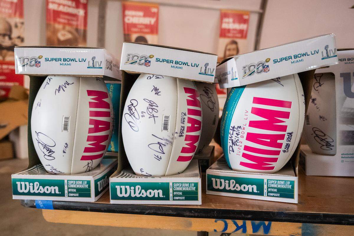 Signed Super Bowl LIV footballs on display at The Pavilion at GEHA Field at Arrowhead Stadium on Friday, February 20, 2026. Fans can come and shop on Saturday for items such as game worn jerseys, practice gear, and cleats.