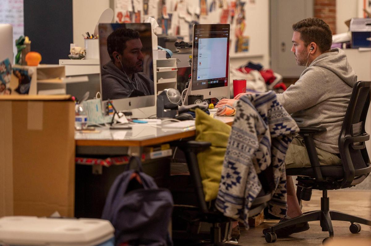 Production artist Brad Allen works from his office desk at Charlie Hustle headquarters.
