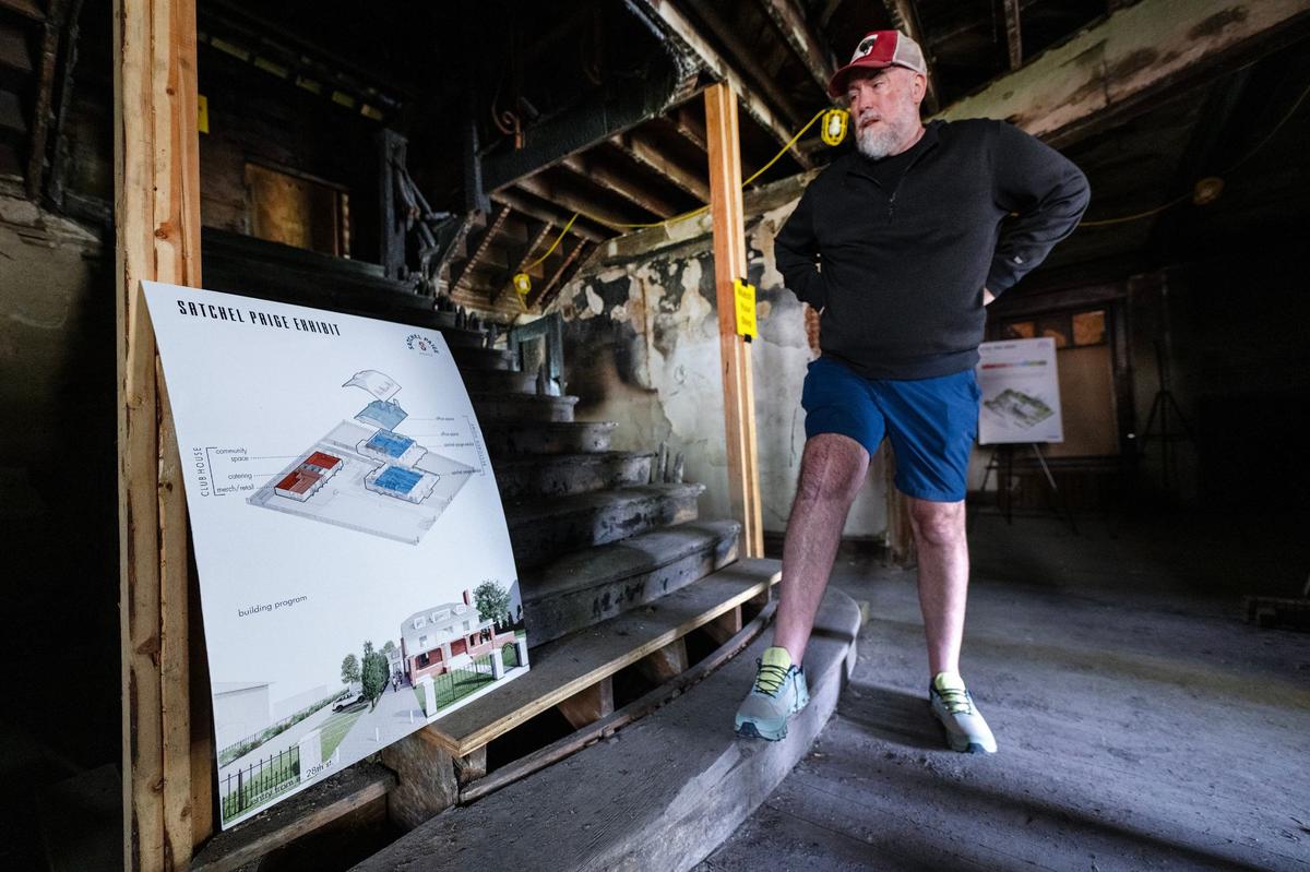 Architect Robert Riccardi of Multistudio displays plans for the restoration of Satchel Paige’s home at 2626 E. 28th St., devastated by fire in 2018. Planners hope a $750,000 grant from the Mellon Foundation of New York will boost local support and donations.
