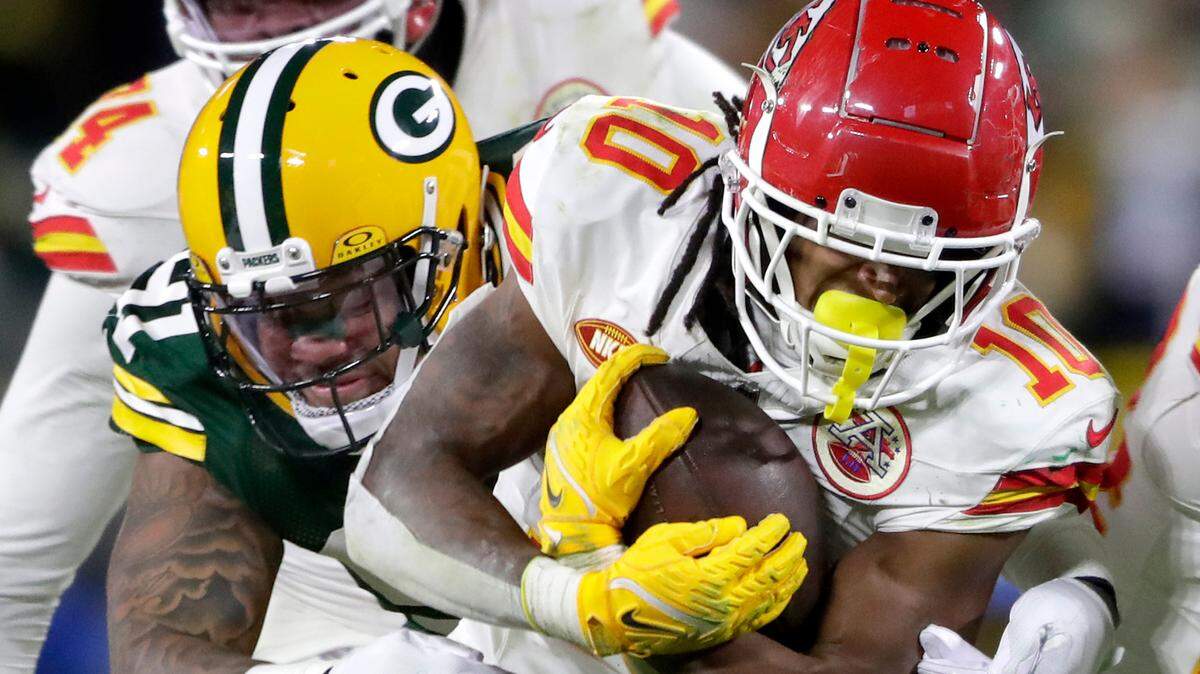 Chiefs running back Isiah Pacheco carries Green Bay Packers linebacker Preston Smith for a few extra yards during Sunday night’s game at Lambeau Field.