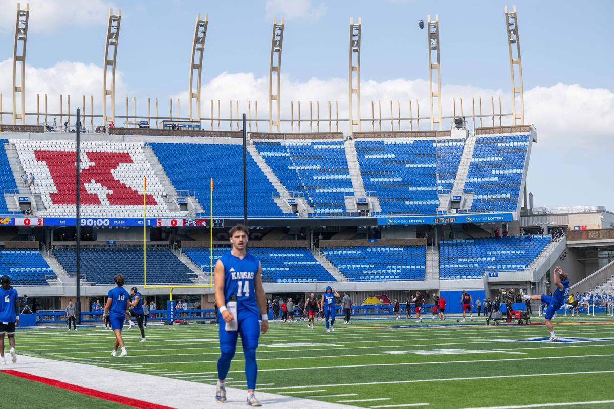 Kansas Jayhawks football players walk the field and check out the new David Booth Kansas Memorial Stadium on Saturday, Aug. 23, 2025, in Lawrence.