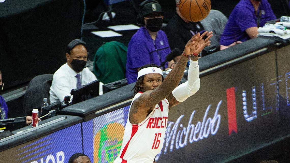 Sacramento Kings guard De’Aaron Fox (5) holds onto Houston Rockets guard Ben McLemore (16) in the second quarter during a game at Golden 1 Center on Thursday, Mar. 11, 2021 in Sacramento.