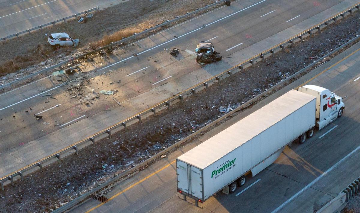 Kansas City police work the scene of a fatal crash on Interstate 435 near Missouri 210 highway on Tuesday, Jan. 2, 2024, in Kansas City. Two people died after a vehicle being chased by police was headed the wrong way on I-435 and crashed head-on into another vehicle.