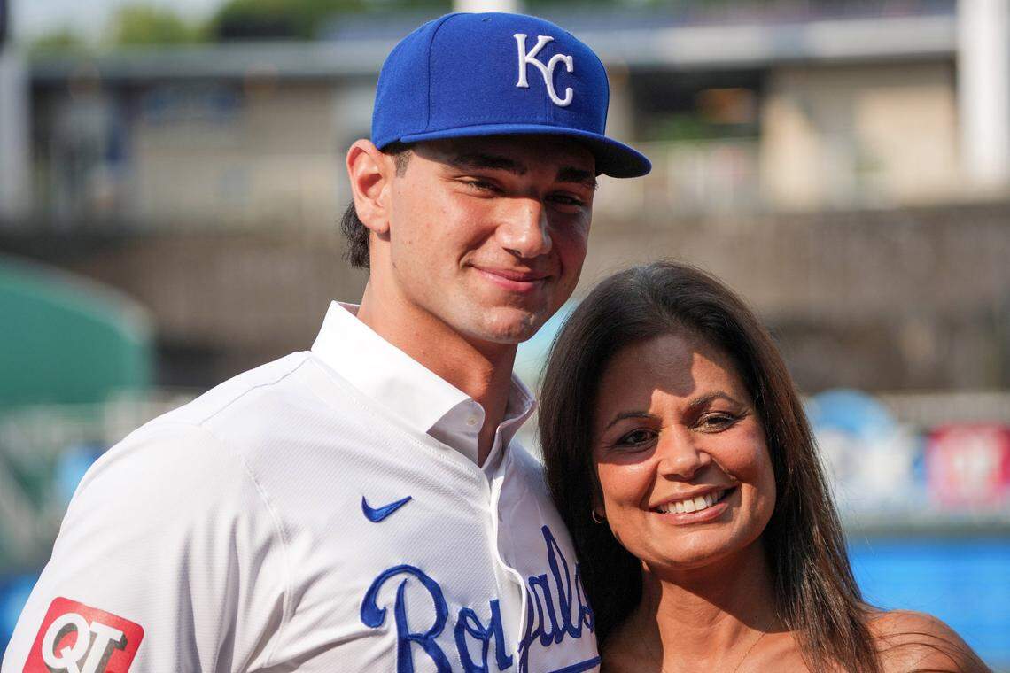 Kansas City Royals first round draft pick Jac Caglianone poses with his mother Johanne Caglianone for photos on the field prior to a game against the Arizona Diamondbacks at Kauffman Stadium on July 24, 2024.