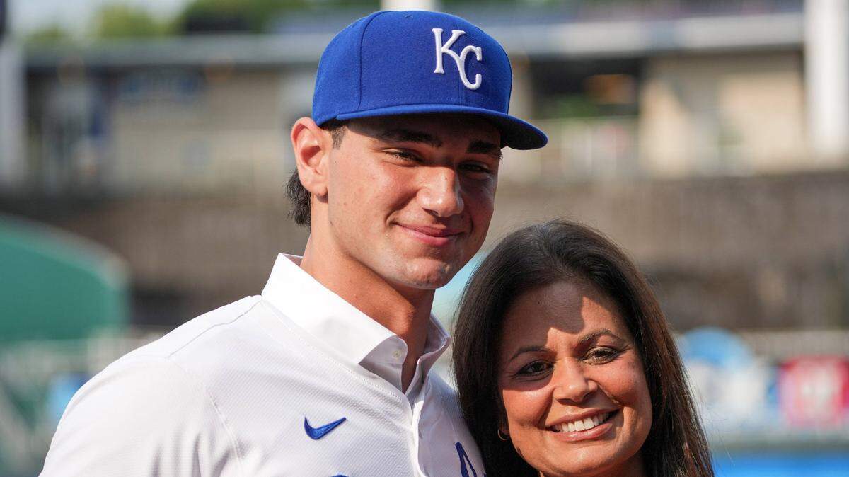 Kansas City Royals first round draft pick Jac Caglianone poses with his mother Johanne Caglianone for photos on the field prior to a game against the Arizona Diamondbacks at Kauffman Stadium on July 24, 2024.