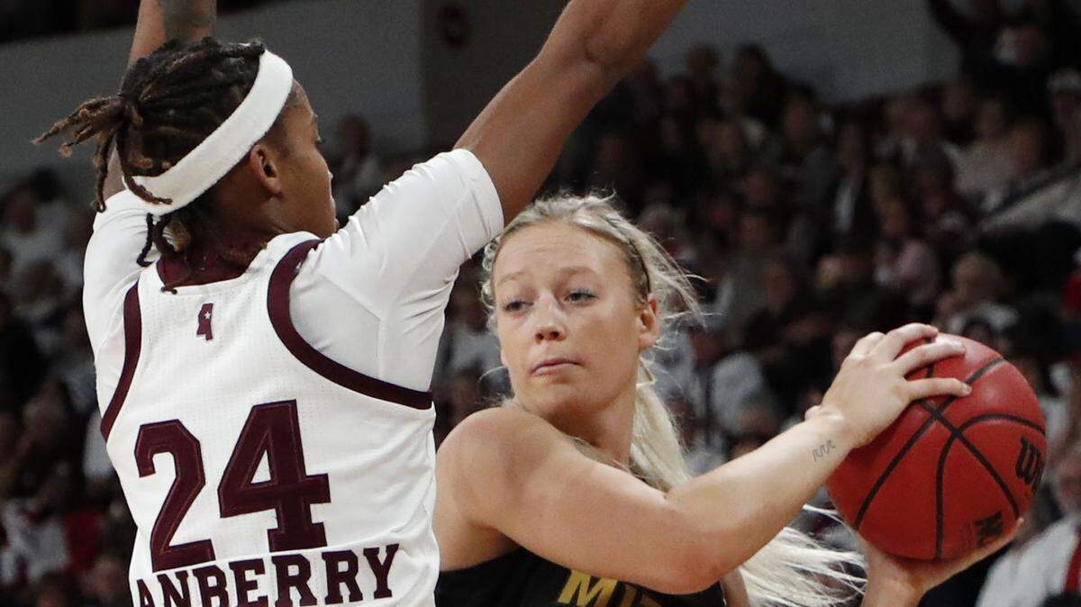 Missouri guard Sophie Cunningham (3) looks for an open teammate while Mississippi State guard Jordan Danberry (24) defends during the first half of an NCAA college basketball game, Thursday, Feb. 14 2019, in Starkville, Miss. (AP Photo/Rogelio V. Solis)