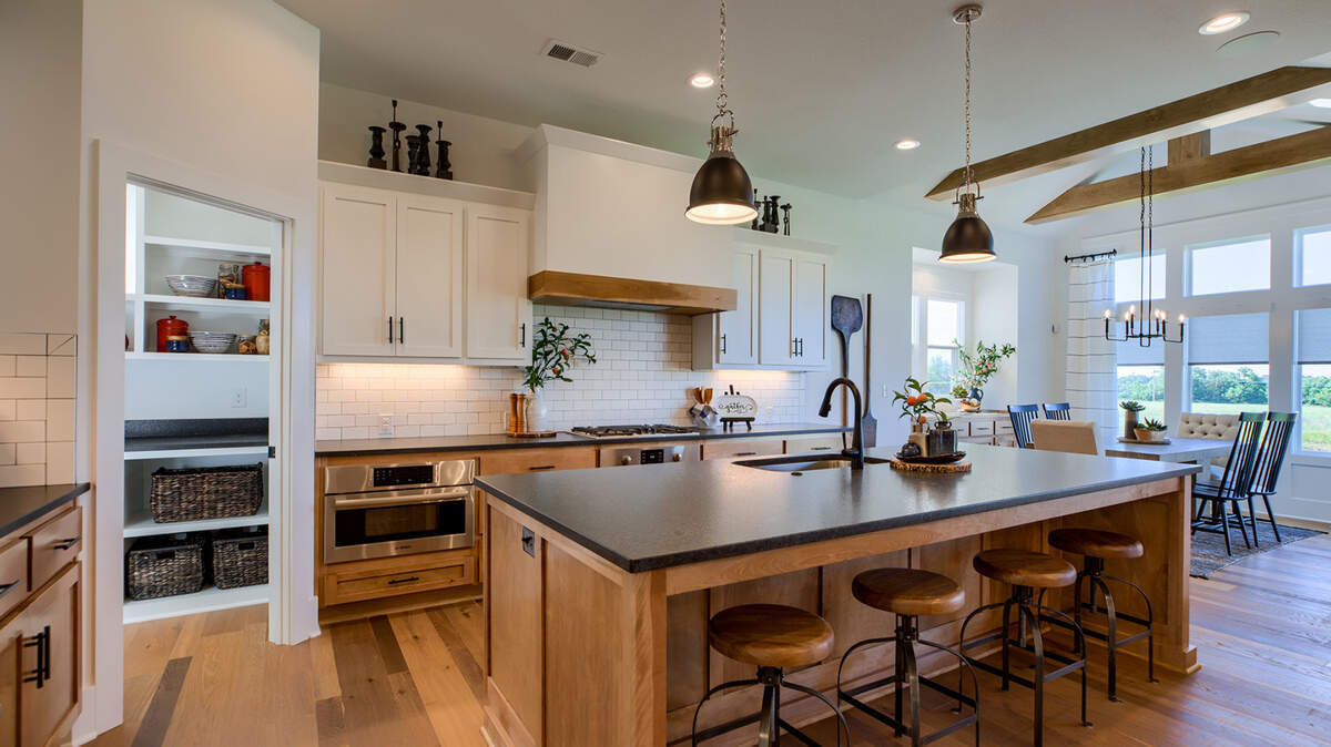 An incredible five Rodrock communities unveiled new model rows this year. Among the collection is the Emery II by James Engle Custom Homes in Olathe’s Stonebridge Park. This award-winning plan boasts an open kitchen with an oversized island, walk-in pantry, and granite.