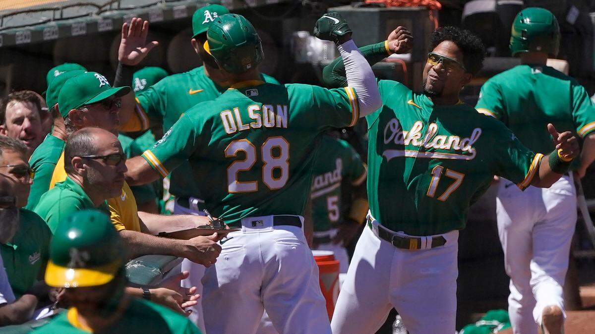 Oakland Athletics’ Matt Olson (28) is congratulated by Elvis Andrus (17) after hitting a home run against the Kansas City Royals during the fifth inning of a baseball game in Oakland, Calif., Sunday, June 13, 2021. (AP Photo/Jeff Chiu)