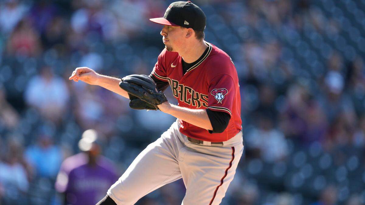 In this file photo, Taylor Clarke delivers a pitch for the Arizona Diamondbacks in August. The reliever on Wednesday agreed to a one-year deal with the Kansas City Royals.