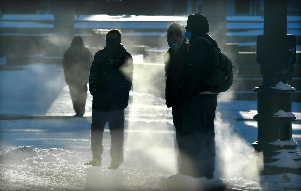 With wind chills dipping well below zero Tuesday morning, pedestrians navigated the frozen streets of downtown Kansas City, near 12th and Central. Many in the area were homeless and forced to leave the shelter set up at Bartle Hall where they spent the night. Wind chills were expected to be below zero again Tuesday night and the forecast for Wednesday called for cloudy skies and a high of 20.