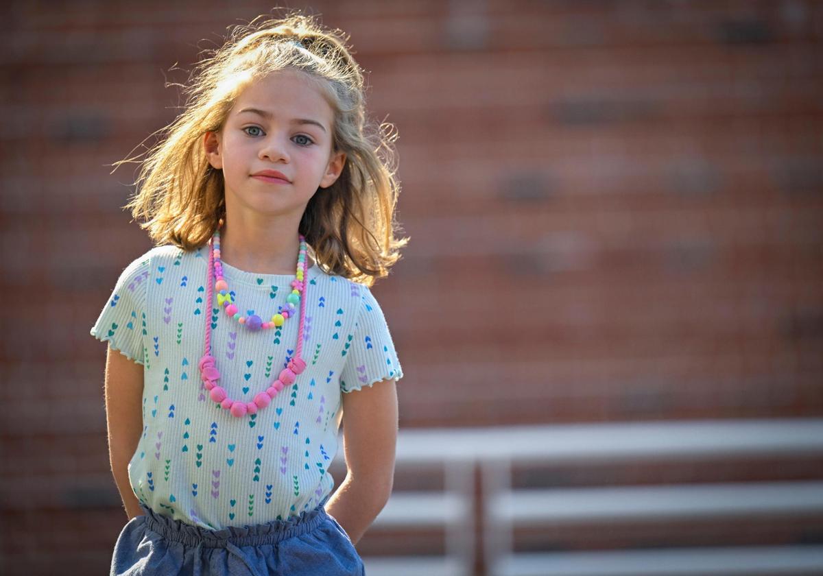 Hattie Foster, 6, has SYNGAP1, a neurological disorder, which her parents said includes intellectual disabilities, gastro issues, autism, sleep issues, aggression, gait issues and epilepsy. She played outside at Prairie Elementary School on Sunday, April 2, 2023, in Prairie Village. Her parents take her to parks and playgrounds during off times because Hattie can be aggressive toward other children.