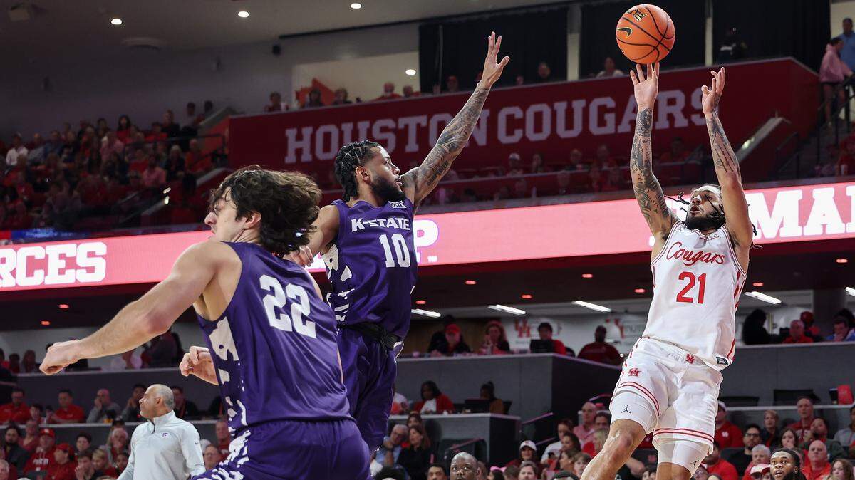 Emanuel Sharp #21 of the Houston Cougars shoots against David Castillo #10 of the Kansas State Wildcats in the first half at Fertitta Center on February 14, 2026 in Houston.