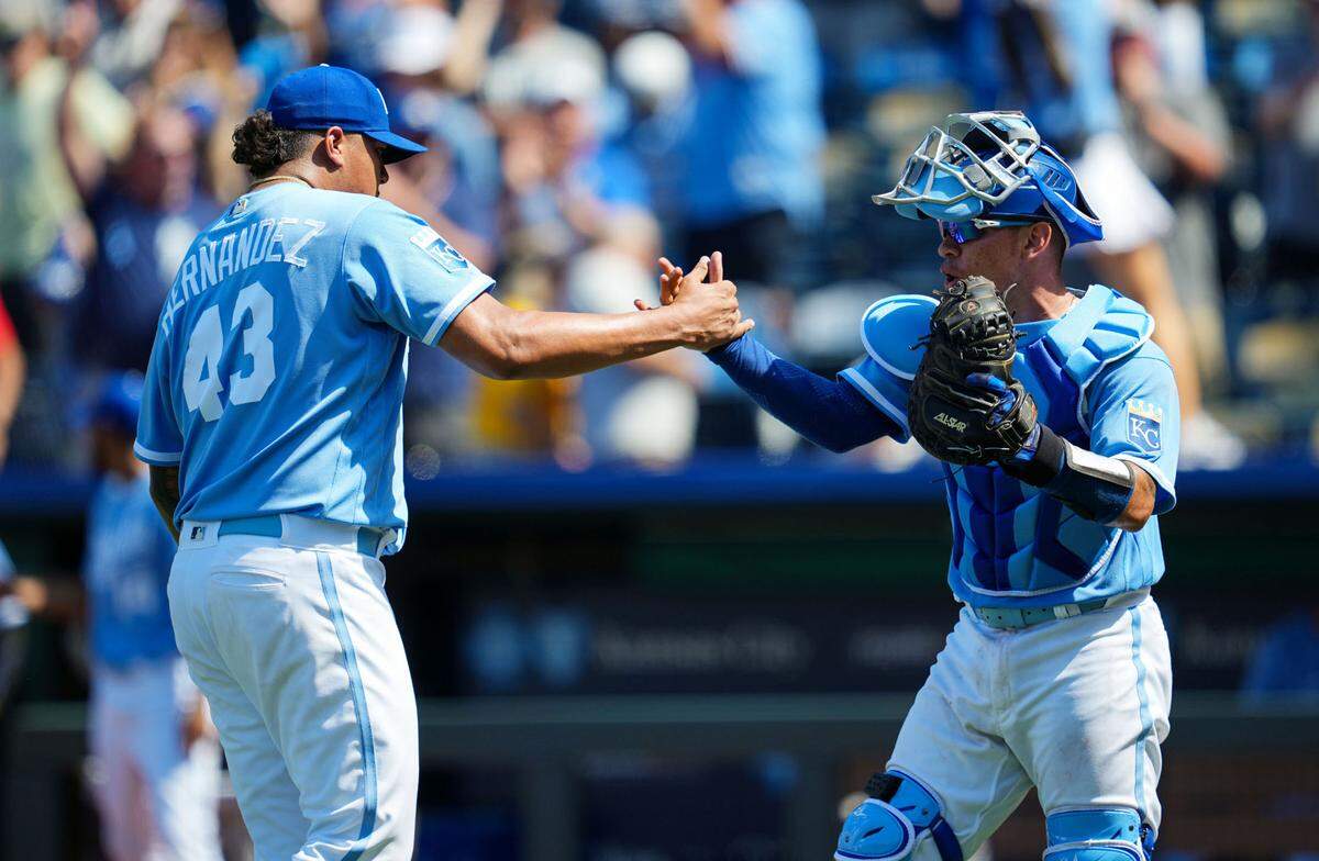 Kansas City Royals relief pitcher Carlos Hernandez (43) celebrates with catcher Freddy Fermin (34) after defeating the Minnesota Twins at Kauffman Stadium on July 30, 2023.