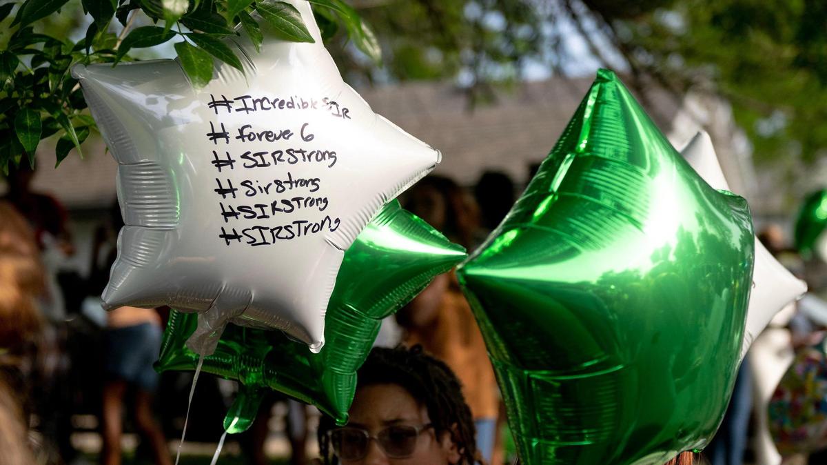 Balloons feature hashtags honoring 6-year-old Sir’Antonio Brown during a vigil on Wednesday, May 10, 2023, in Kansas City, Kan. Brown was killed May 3 while playing outside his home.