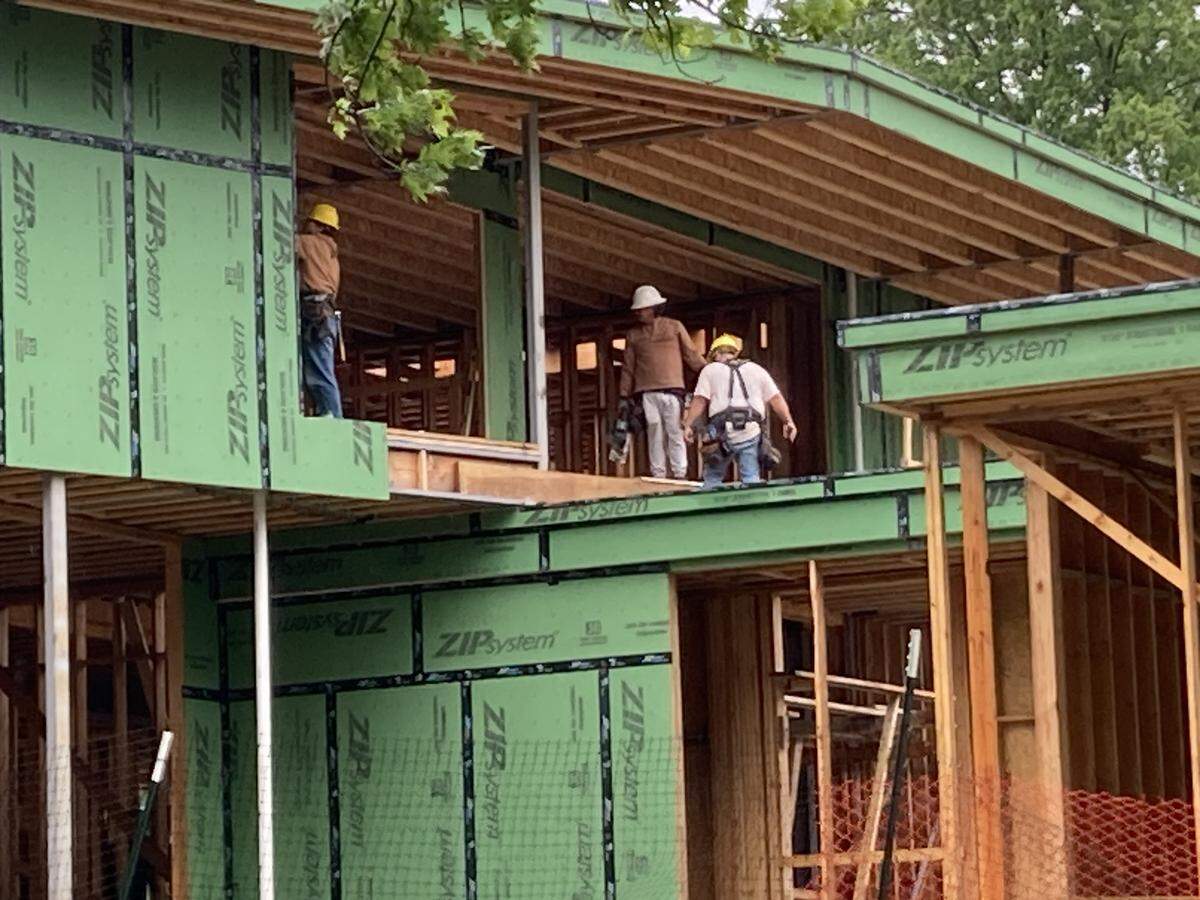 Construction workers on the top floor of a $7 million mansion now under construction at 6315 Ward Parkway, a lot that once contained the home of the late Richard Bloch of H&R Block.