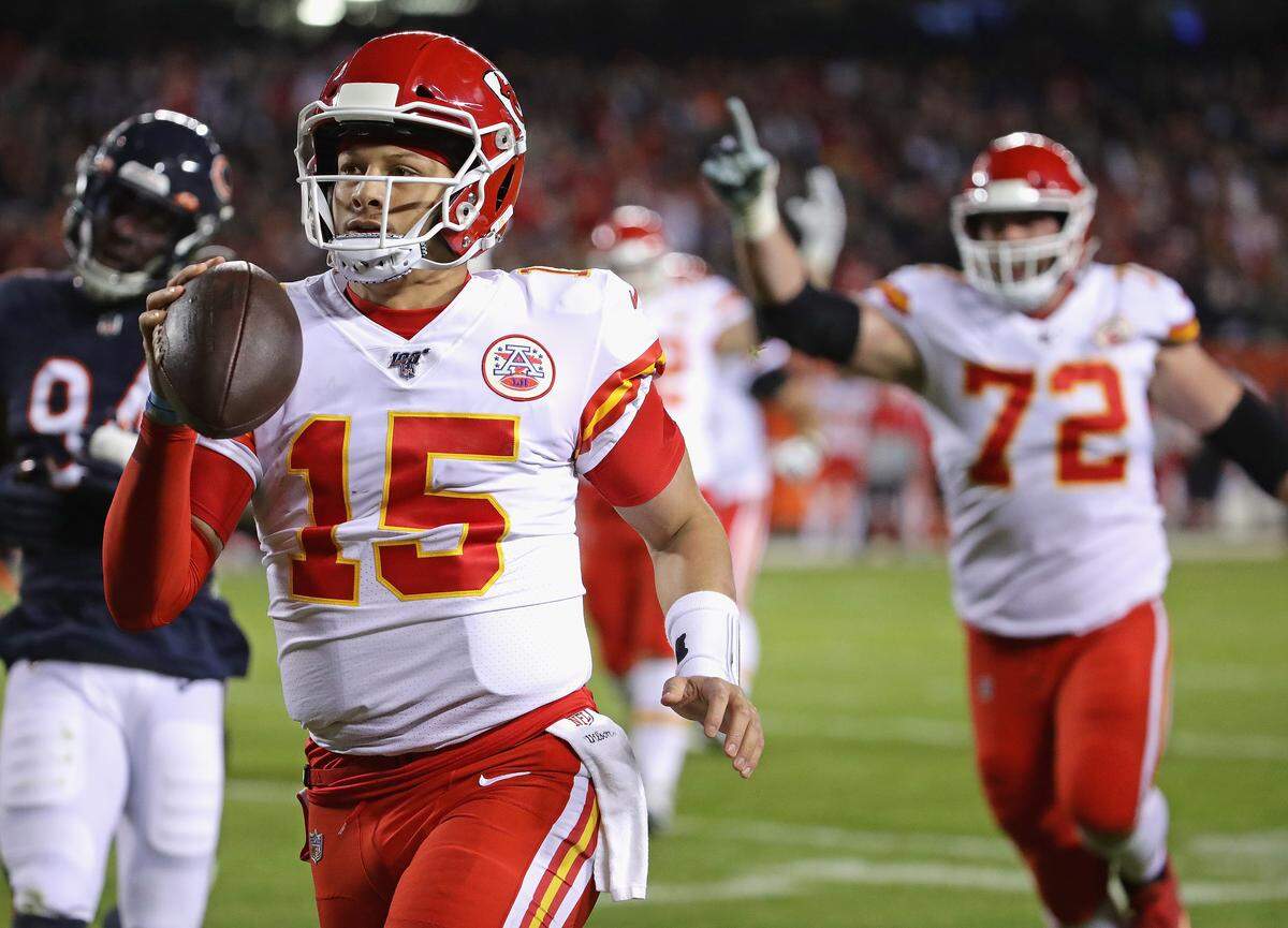 Patrick Mahomes #15 of the Kansas City Chiefs runs for touchdown followed by teammate Eric Fisher #72 against the Chicago Bears at Soldier Field on December 22, 2019, in Chicago.