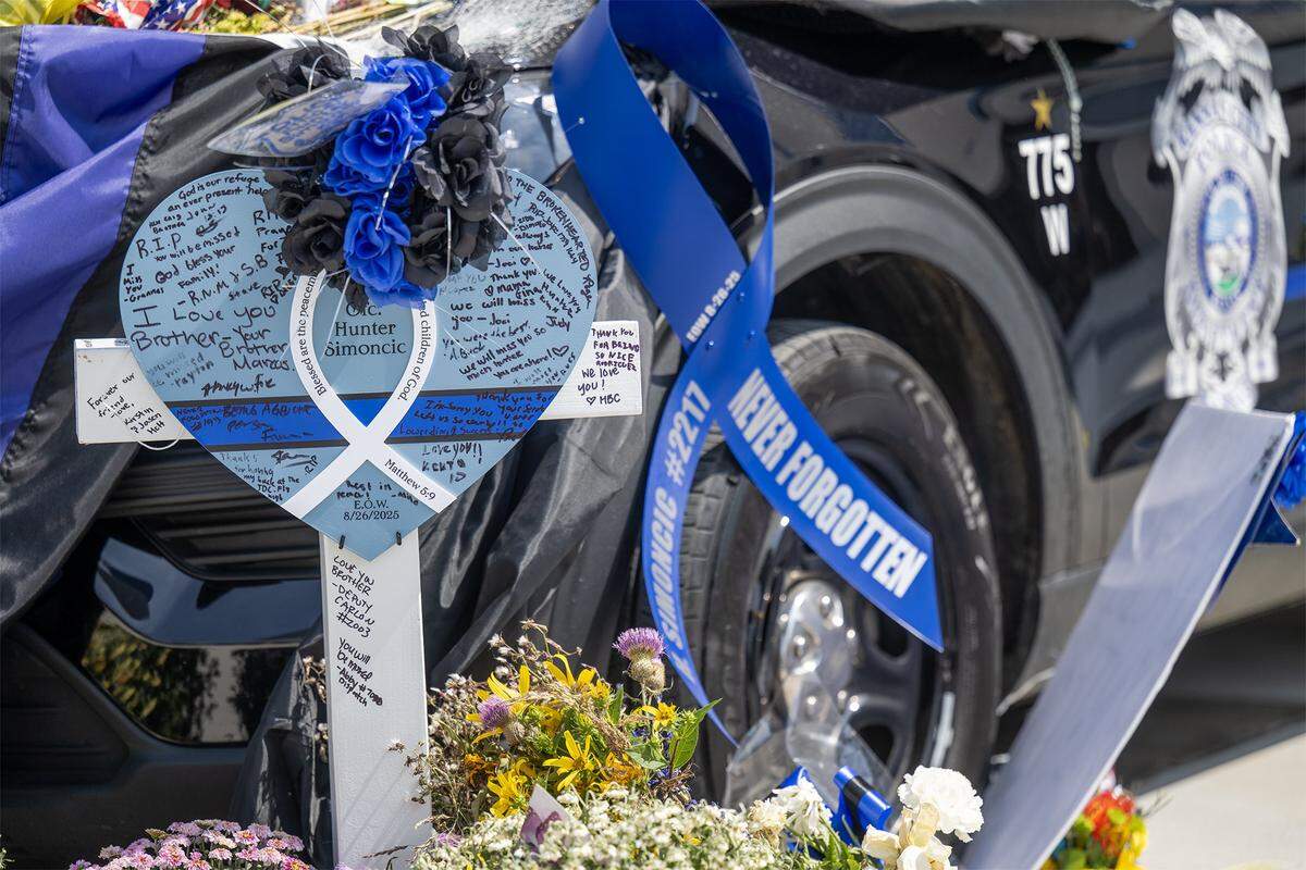 Tributes were left for Kansas City, Kansas Police Officer Hunter Simoncic near his patrol vehicle on display in downtown Kansas City, Kansas, on Wednesday, Sept. 3, 2025.