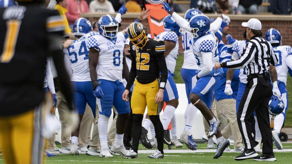 Kentucky teammates celebrate after they recovered a fumble by Missouri quarterback Brady Cook, center, during the second quarter of an NCAA college football game Saturday, Nov. 5, 2022, in Columbia, Mo. (AP Photo/L.G. Patterson)