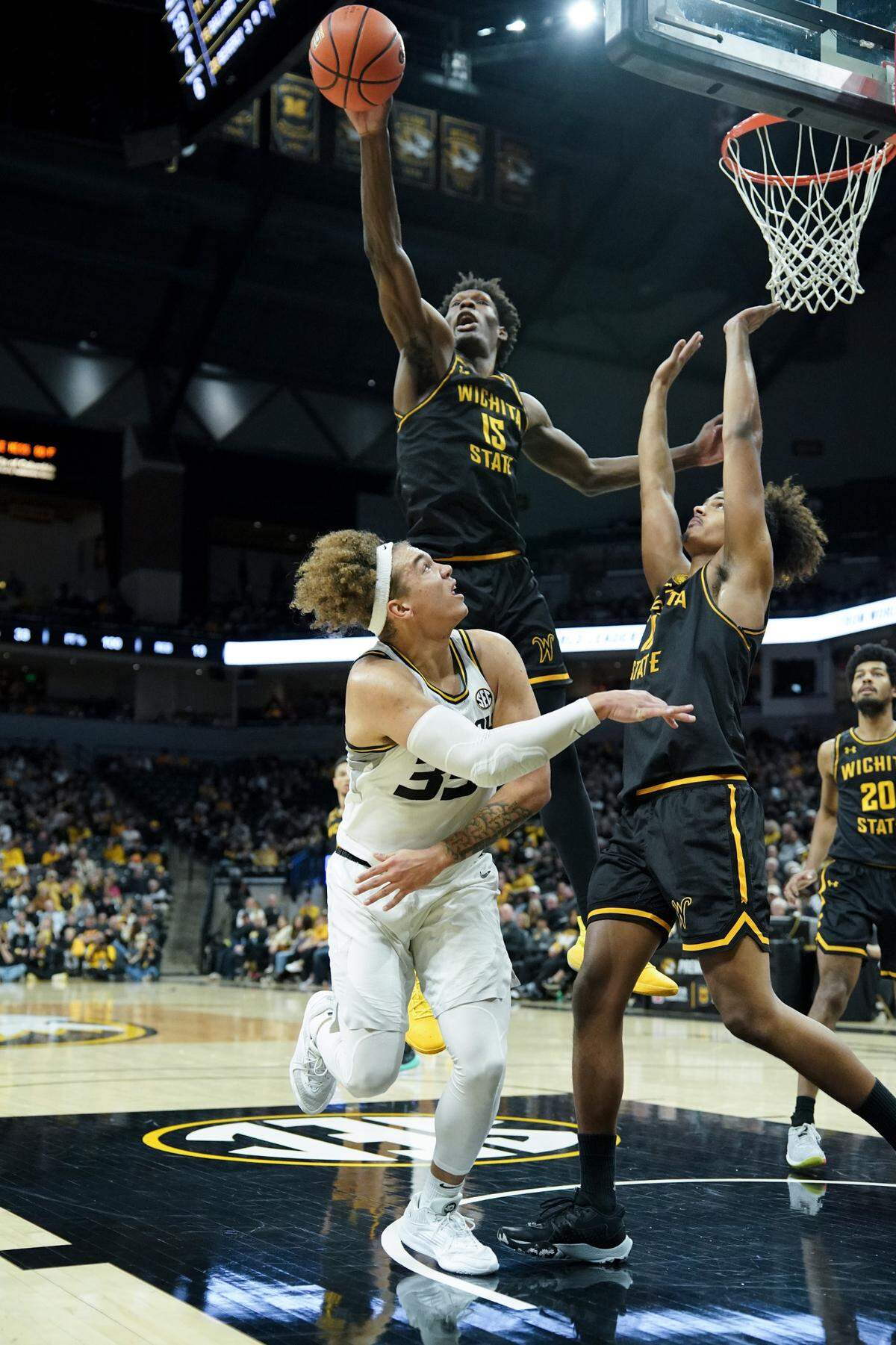Wichita State Shockers center Quincy Ballard, top, blocks a shot attempt by Missouri Tigers forward Noah Carter during Sunday afternoon’s game at Mizzou Arena.