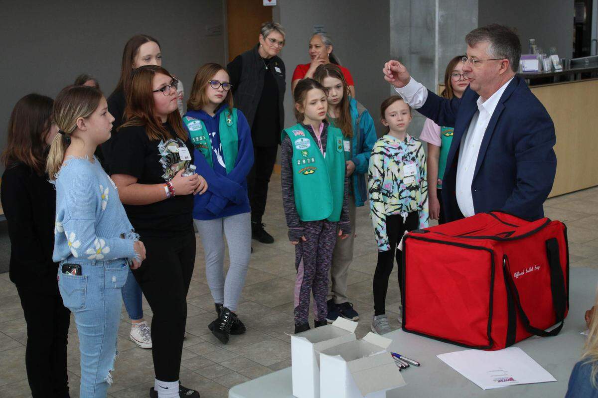 Johnson County Election Commissioner Fred Sherman shows a group of Junior Girl Scouts how he seals an official ballot box during the Voter Girl Project program Jan. 28 in Olathe.