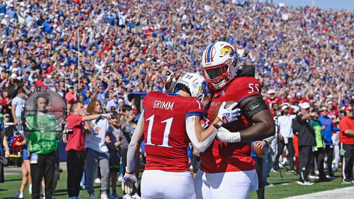 Kansas Jayhawks wide receiver Luke Grimm celebrates with offensive lineman Ar’maj Reed-Adams after catching a touchdown pass against TCU on Saturday. KU went on to lose 38-31 to the Horned Frogs at David Booth Memorial Stadium in Lawrence, Kan.