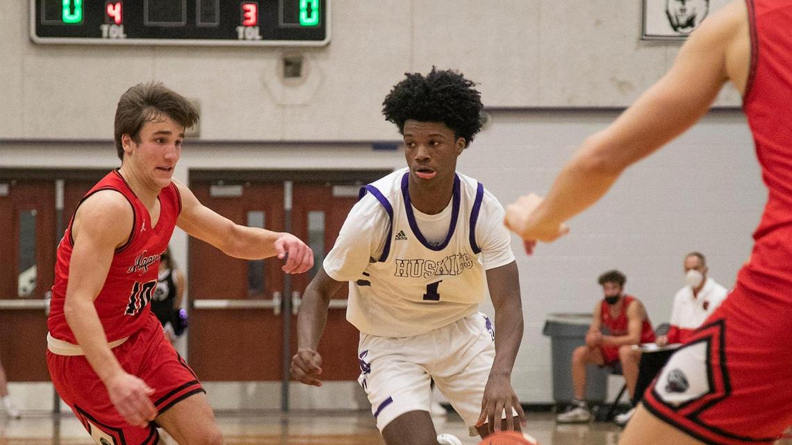 Alston Mason #1, of Blue Valley North West, drives past Sam Ungashick, #10 of Blue Valley West during the game Friday, Jan. 8, 2021at Blue Valley North West.